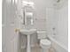 Bathroom features a tub with shower, pedestal sink, decorative mirror and a neutral color palette at 107 Myers Farm Ct, Cary, NC 27519