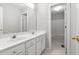Bathroom with double sink vanity and tile floors, leading to toilet and shower at 107 Myers Farm Ct, Cary, NC 27519
