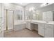 Bathroom with tiled floor, soaking tub, shower, dual sink vanity, and ample storage at 107 Myers Farm Ct, Cary, NC 27519
