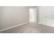 Bedroom featuring neutral carpet and paint, closet, and open door at 107 Myers Farm Ct, Cary, NC 27519