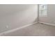 Carpeted bedroom with neutral paint and window providing natural light at 107 Myers Farm Ct, Cary, NC 27519
