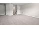 Spacious bonus room with neutral carpet and paint featuring multiple doors at 107 Myers Farm Ct, Cary, NC 27519
