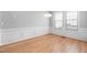 Bright dining room with hardwood floors, crown molding, and natural light from large windows at 107 Myers Farm Ct, Cary, NC 27519
