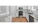 Well-lit kitchen with stainless steel appliances, granite countertops, subway tile backsplash, and hardwood floors at 107 Myers Farm Ct, Cary, NC 27519