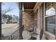 Relaxing covered porch with two wicker chairs and wrought iron railings at 1113 Magnolia Bend Loop, Cary, NC 27519