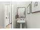 Elegant powder room with pedestal sink and framed art at 1135 Laurelwood Dr, Durham, NC 27705