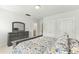 Spacious bedroom with dresser and ensuite bathroom access at 1135 Laurelwood Dr, Durham, NC 27705