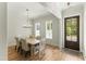 Light and airy dining room with a large wooden table at 1135 Laurelwood Dr, Durham, NC 27705