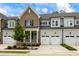 Attractive brick and gray townhome with white garage doors at 1135 Laurelwood Dr, Durham, NC 27705