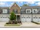 Brick front townhome with 2-car garage and landscaped yard at 1135 Laurelwood Dr, Durham, NC 27705