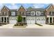 Townhome building with three units and white garages at 1135 Laurelwood Dr, Durham, NC 27705