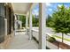 Covered porch with black railing, brick and white columns at 1135 Laurelwood Dr, Durham, NC 27705
