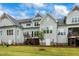 Gray house back with wooden deck and stairs at 1135 Laurelwood Dr, Durham, NC 27705