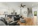 Open concept kitchen and living area with white cabinets, island, and gray sofas at 1135 Laurelwood Dr, Durham, NC 27705