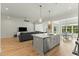 Open floor plan with modern kitchen and living space, hardwood floors, and island at 1135 Laurelwood Dr, Durham, NC 27705