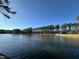 Serene lake view surrounded by tall trees at 1135 Laurelwood Dr, Durham, NC 27705