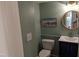 Powder room with a navy vanity and a round mirror at 1408 Brigham Rd, Chapel Hill, NC 27517