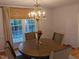 Dining room features hardwood floors, chandelier, and large window at 1408 Brigham Rd, Chapel Hill, NC 27517