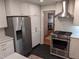 Stainless steel appliances and white shaker cabinets in kitchen at 1408 Brigham Rd, Chapel Hill, NC 27517