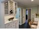White cabinets, marble countertops, and wine rack in kitchen at 1408 Brigham Rd, Chapel Hill, NC 27517