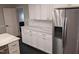 Updated kitchen features white cabinets, marble countertops, and stainless steel appliances at 1408 Brigham Rd, Chapel Hill, NC 27517
