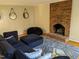 Living room featuring a brick fireplace and comfy seating at 1408 Brigham Rd, Chapel Hill, NC 27517