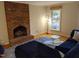 Living room with brick fireplace and stylish rug at 1408 Brigham Rd, Chapel Hill, NC 27517