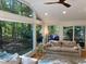 Sunroom with large windows, hardwood floors, and ceiling fan at 1408 Brigham Rd, Chapel Hill, NC 27517