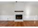 White brick fireplace with wooden mantel in living room at 1437 Huntly Ct, Cary, NC 27511