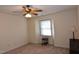 Well-lit bedroom with window, ceiling fan, and ample floor space at 1511 Creekwood Ct # 102, Raleigh, NC 27603