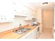 White kitchen cabinets and wood countertops at 1511 Creekwood Ct # 102, Raleigh, NC 27603