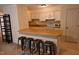 Kitchen with breakfast bar and four metal stools at 1511 Creekwood Ct # 102, Raleigh, NC 27603