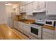 Bright kitchen features white cabinets, wood countertops, and modern appliances at 1511 Creekwood Ct # 102, Raleigh, NC 27603