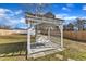 White wooden pergola with a swing bench, ideal for relaxing outdoors at 1605 Thompson St, Raleigh, NC 27603