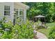 Landscaped backyard with stone patio and flowers at 1724 Bowling Green Trl, Raleigh, NC 27613