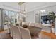 Bright dining room with large windows, chandelier, and hardwood floors at 1724 Bowling Green Trl, Raleigh, NC 27613