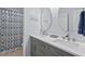 Stylish bathroom featuring a double vanity with modern faucets and a well-lit mirror at 200 Callandale Ln, Durham, NC 27703