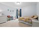 Cozy bedroom featuring a twin bed, dresser, and a bright window with view at 200 Callandale Ln, Durham, NC 27703