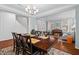 Bright dining area with chandelier, hardwood floors, and views of the living room at 200 Callandale Ln, Durham, NC 27703
