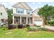 Attractive two-story home boasts lush landscaping, a stone facade, and a cozy front porch area at 200 Callandale Ln, Durham, NC 27703