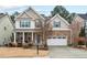 Beautiful two-story home boasts stone accents, neutral siding, and a well-manicured lawn at 200 Callandale Ln, Durham, NC 27703