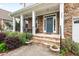 Inviting front porch with stone columns, steps, stylish railings, and decorative potted plants at 200 Callandale Ln, Durham, NC 27703