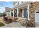 Inviting front porch features stone accents, stately columns, and a charming blue front door at 200 Callandale Ln, Durham, NC 27703