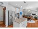 Open concept kitchen with stainless steel refrigerator, granite island, and view to living spaces at 200 Callandale Ln, Durham, NC 27703