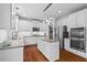 Modern kitchen with white cabinetry, granite countertops, stainless steel appliances, and wood flooring at 200 Callandale Ln, Durham, NC 27703