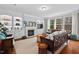 Cozy living room with built-in shelving, fireplace, and large windows overlooking the backyard at 200 Callandale Ln, Durham, NC 27703
