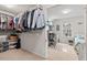 Bright walk-in closet with ample storage and shelving, leading to a cozy room with a desk and natural light at 200 Callandale Ln, Durham, NC 27703