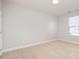 Bright bedroom featuring neutral walls, carpet, and window with blinds at 203 Shale Creek Dr, Durham, NC 27703