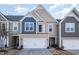 Tan and blue two-story townhome with white garage door at 203 Shale Creek Dr, Durham, NC 27703