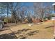 Large backyard with playset and trees at 2419 Highland Ave, Durham, NC 27704